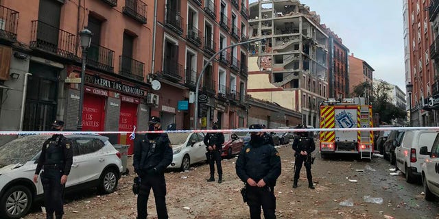Police officers cordon off Toledo Street following an explosion in downtown Madrid, Spain, Wednesday, Jan. 20, 2021. (AP Photo/Bernat Armangue)