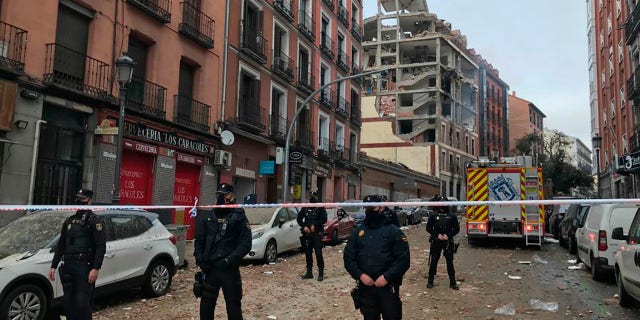 Police officers cordon off Toledo Street following an explosion in downtown Madrid, Spain, Wednesday, Jan. 20, 2021. (AP Photo/Bernat Armangue)