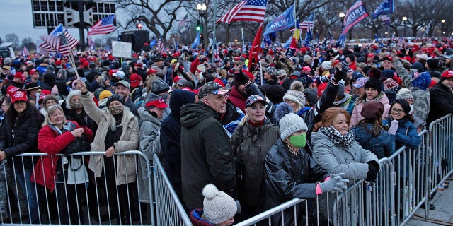 People wait for a rally of supporters of President Donald Trump challenging the results of the 2020 U.S. presidential election on the Ellipse outside of the White House on January 6, 2021, in Washington, DC. (Photo by Brendan Smialowski/AFP via Getty Images)