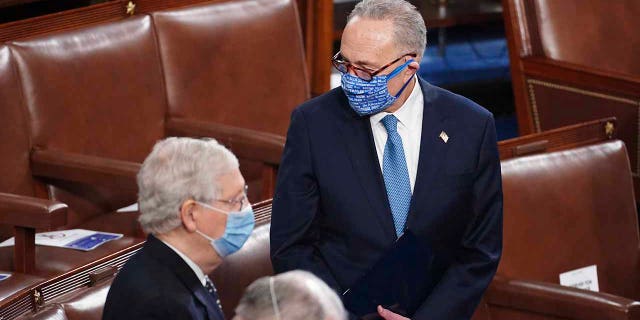 Charles Schumer, DN.Y., stands with Mitch McConnell, R-Ky., As a joint sitting of the House and Senate meet to confirm the votes of the Electoral College in the November election at the Capitol in Washington, Wednesday, January 6th.  , 2021. (Kevin Dietsch / Pool via AP)