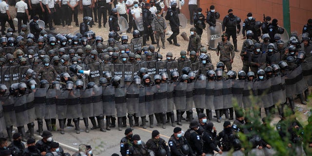 Guatemalan soldiers and police block Honduran migrants from advancing toward the US border, on the highway in Vado Hondo, Guatemala, Monday, Jan. 18, 2021. (AP Photo/Sandra Sebastian)