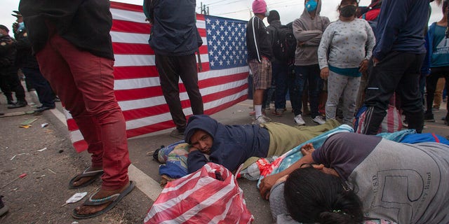 Honduran migrants rest as they are blocked by Guatemalan soldiers and police from advancing toward the US border, on the highway in Vado Hondo, Guatemala, Monday, Jan. 18, 2021. (AP Photo/Sandra Sebastian)