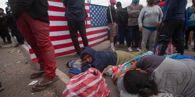 Honduran migrants rest as they are blocked by Guatemalan soldiers and police from advancing toward the US border, on the highway in Vado Hondo, Guatemala, Monday, Jan. 18, 2021. (AP Photo/Sandra Sebastian)