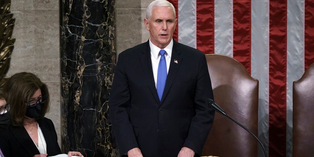 Vice President Mike Pence listens after reading the final certification of Electoral College votes cast in November's presidential election during a joint session of Congress after working through the night, at the Capitol in Washington, Thursday, Jan. 7, 2021. Violent protesters loyal to President Donald Trump stormed the Capitol Wednesday, disrupting the process. (AP Photo/J. Scott Applewhite, Pool)