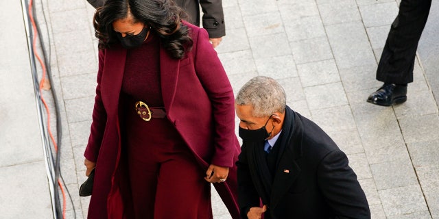 The former first lady wore a purple, almost burgundy overcoat by Black American designer Sergio Hudson for Wednesday's event, completed with a matching belt cinched at her waist with a gold circle buckle.