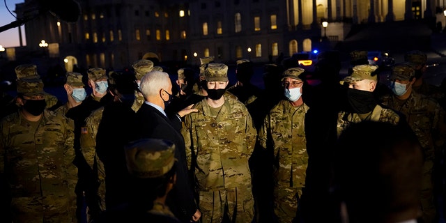 Vice President Mike Pence speaks to National Guard troops outside the U.S. Capitol, Thursday, Jan. 14, 2021, in Washington. (AP Photo/Alex Brandon, Pool)