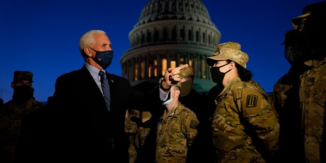 Vice President Mike Pence speaks to National Guard troops outside the U.S. Capitol, Thursday, Jan. 14, 2021, in Washington. (AP Photo/Alex Brandon, Pool)