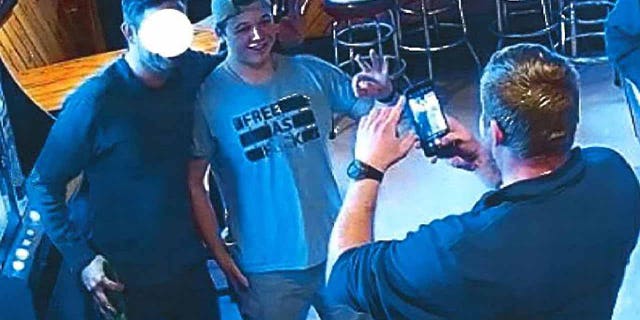 As part of an affidavit under oath before Kenosha County Circuit Court, Assistant District Attorney Thomas C. Binger submitted several stills from the video that show Kyle Rittenhouse posing for several photographs in a t-shirt which reads "Free like F ** k" with other adult men in the bar.  In each photo, the accused and the other adult men blink "Okay" sign.