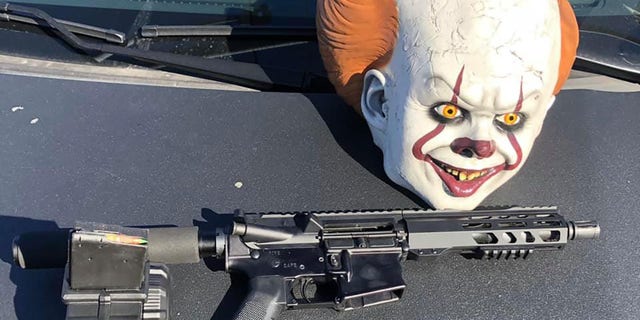 A loaded AR-15 style rifle, a clown mask and marijuana were found inside the vehicle, police said.