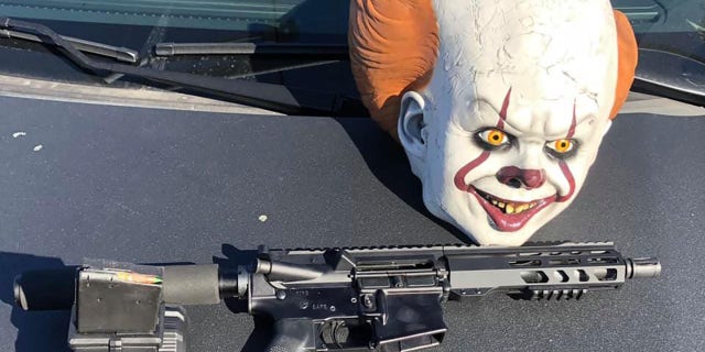 A loaded AR-15 style rifle, a clown mask and marijuana were found inside the vehicle, police said.