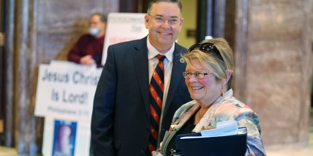 South Carolina Rep. John McCravy, links, and South Carolina Citizens for Life Executive Director Holly Gatling, reg, talk after the state Senate approved a bill that would likely ban almost all abortions in the state on Thursday, Jan.. 28, 2021, in Columbia, S.C. McCravy has worked to pass similar bills in the House. (AP Photo/Jeffrey Collins)