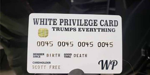 Officers found a "White privilege card" while executing search warrants on Rogers' home and business.  (Department of Justice)