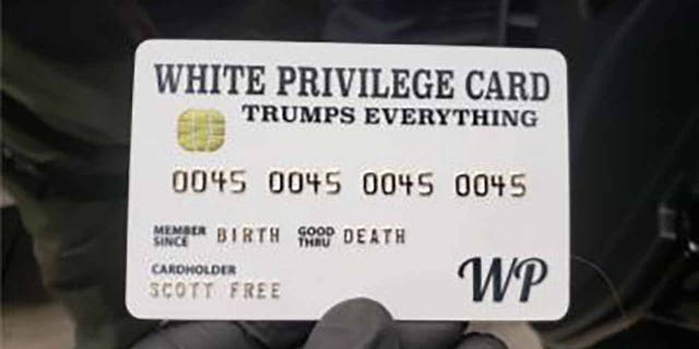 Officers a "White Privilege Card" While executing search warrants for Rogers's home and business. (Justice Department)