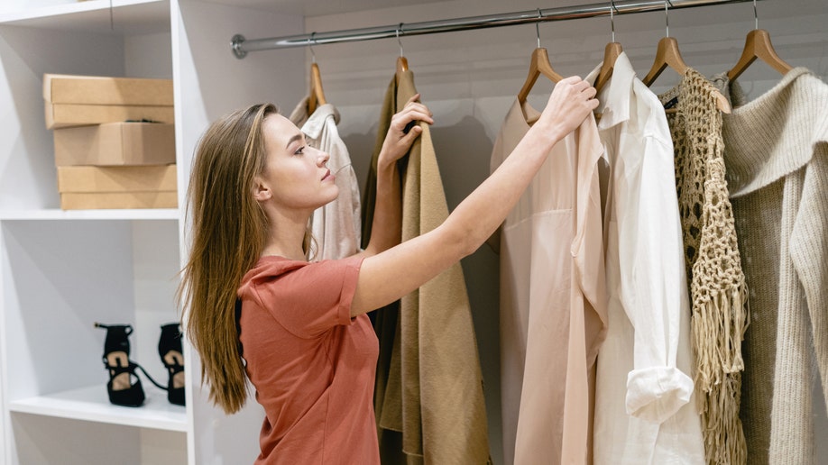 Woman looking at clothing inside a store