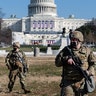 Members of the National Guard stand in front of the U.S. Capitol in Washington, D.C., on Wednesday, Jan. 13, 2021. President Donald Trump was impeached by the U.S. House on a single charge of incitement of insurrection for his role in a deadly riot by his supporters that left five dead and the Capitol ransacked. (Eric Lee/Bloomberg via Getty Images)