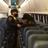An Amtrak K9 officer and his dog check the seats in an Amtrak train before its departure from Union Station as security is heightened ahead of President-elect Joe Biden's inauguration ceremony, Tuesday, Jan. 19, 2021, in Washington.