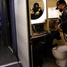 An Amtrak K9 officer and his dog check the lavatory in an Amtrak train before its departure from Union Station as security is heightened ahead of President-elect Joe Biden's inauguration ceremony, Tuesday, Jan. 19, 2021, in Washington.