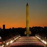 A field of flags is spread across the National Mall, with the Washington Monument in the background on Tuesday, Jan. 19, 2021, as seen from the West Front of the U.S. Capitol on the evening ahead of the 59th Presidential Inauguration in Washington.
