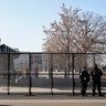 Capitol police officers stand outside of fencing that was installed around the exterior of the Capitol grounds, Thursday, Jan. 7, 2021 in Washington. The House and Senate certified the Democrat's electoral college win early Thursday after a violent throng of pro-Trump rioters spent hours Wednesday running rampant through the Capitol. A woman was fatally shot, windows were bashed and the mob forced shaken lawmakers and aides to flee the building, shielded by Capitol Police. (AP Photo/John Minchillo)