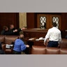 Police with guns drawn watch as protesters try to break into the House Chamber at the U.S. Capitol on Wednesday, Jan. 6, 2021, in Washington.