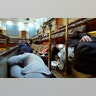 People shelter in the House gallery as protesters try to break into the House Chamber at the U.S. Capitol on Wednesday, Jan. 6, 2021, in Washington.