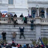 Supporters of President Trump climb the west wall of the the U.S. Capitol on Wednesday, Jan. 6, 2021, in Washington.