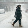 A pedestrian crosses a snow-covered street, Monday, Jan. 25, 2021, in downtown Des Moines, Iowa. A major winter storm is expected to blanket a large swath of the middle of the country with snow Monday and disrupt travel as more than a foot of snow falls in some areas.