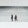 Pedestrians cross a snow-covered street, Monday, Jan. 25, 2021, in downtown Des Moines, Iowa. A major winter storm is expected to blanket a large swath of the middle of the country with snow Monday and disrupt travel as more than a foot of snow falls in some areas.