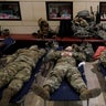 National Guardsmen sleep inside the Capitol Visitor Center at the Capitol in Washington, Monday, Jan. 18, 2021.