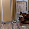 A U.S. Capitol Police officer walks past damage in the early morning hours of Thursday, Jan. 7, 2021, after protesters stormed the Capitol in Washington, on Wednesday. 