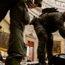 Rep. Andy Kim, D-N.J., helps ATF police officers clean up debris and personal belongings strewn across the floor of the Rotunda in the early morning hours of Thursday, Jan. 7, 2021, after protesters stormed the Capitol in Washington on Wednesday.