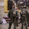After violent protesters loyal to President Donald Trump stormed the U.S. Capitol on Wednesday, a tactical team with ATF gathers in the Rotunda to provide security for the continuation of the joint session of the House and Senate to count the Electoral College votes cast in November's election, at the Capitol in Washington, Wednesday, Jan. 6, 2021.