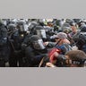 Capitol police officers in riot gear push back demonstrators who try to break a door of the U.S. Capitol on Wednesday, Jan. 6, 2021, in Washington.