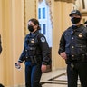 U.S. Capitol Police survey the corridor around the House of Representatives chamber after enhanced security protocols were enacted, including metal detectors for lawmakers, after a mob loyal to President Donald Trump stormed the Capitol, in Washington, Tuesday, Jan. 12, 2021.