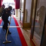 A worker vacuums inside the U.S. Capitol ahead of President-elect Joe Biden's inauguration ceremony, Wednesday, Jan. 20, 2021, in Washington.