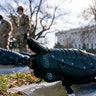 The Dome of the Capitol building is visible as members of the National Guard stand in front of riot gear laid out on a field on Capitol Hill in Washington, Wednesday, Jan. 13, 2021. (AP Photo/Andrew Harnik)