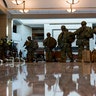 Troops move inside the Capitol Visitor's Center to reinforce security at the Capitol in Washington, Wednesday, Jan. 13, 2021. The House of Representatives is pursuing an article of impeachment against President Donald Trump for his role in inciting an angry mob to storm the Capitol last week. (AP Photo/Alex Brandon)