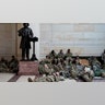 Troops hold inside the Capitol Visitor's Center to reinforce security at the Capitol in Washington, Wednesday, Jan. 13, 2021. The House of Representatives is pursuing an article of impeachment against President Donald Trump for his role in inciting an angry mob to storm the Capitol last week.. (AP Photo/Alex Brandon)