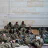 Troops hold inside the Capitol Visitor's Center to reinforce security at the Capitol in Washington, Wednesday, Jan. 13, 2021. The House of Representatives is pursuing an article of impeachment against President Donald Trump for his role in inciting an angry mob to storm the Capitol last week.. (AP Photo/Alex Brandon)