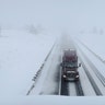 A semi-truck travels on Interstate 40 in Bellemont, Ariz., Monday, Jan. 25, 2021. A series of winter storms have dropped more precipitation in Flagstaff than the city had during last summer's monsoon season. The recent snow measured as water topped the amount of rain that fell from mid-June through September, the driest monsoon season on record. (AP Photo/Felicia Fonseca)