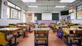 Row of empty desks in front of whiteboard. Interior of classroom in school.