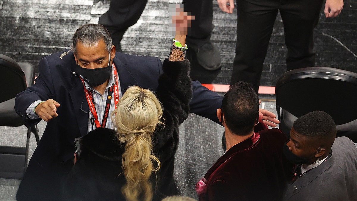  A fan gestures as she and her party are escorted out of the arena during the second half of the game between the Los Angeles Lakers and the Atlanta Hawks at State Farm Arena on Feb. 1, 2021, in Atlanta, Ga. 