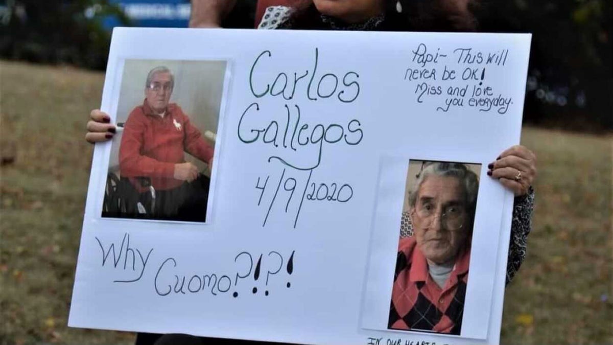 Maria Porteus holds up a sign of her father Carlos Gallegos (Maria Porteus)