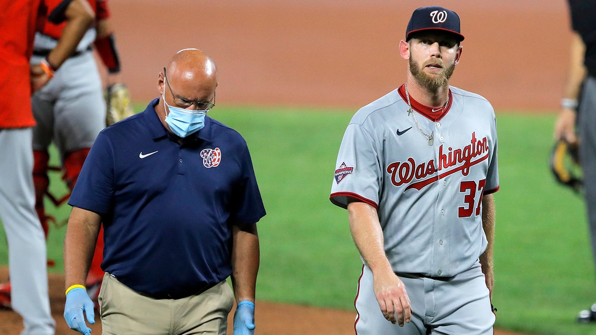 Stephen Strasburg walks towards the dugout