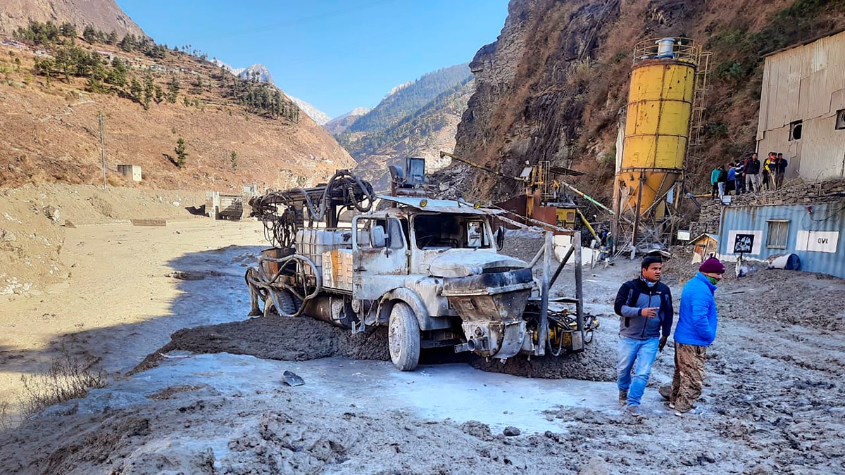 People inspect the site near the damaged Dhauliganga hydropower project at Reni village in Chamoli district after a portion of Nanda Devi glacier broke off in Tapovan area of the northern state of Uttarakhand, Sunday, Feb.7, 2021. (AP Photo)
