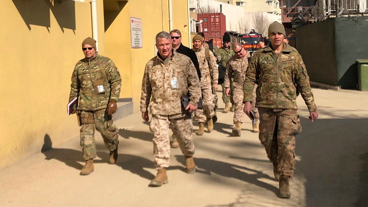 Marine Gen. Frank McKenzie, center, top U.S. commander for the Middle East, makes an unannounced visit in Kabul, Afghanistan. (AP Photos/Lolita Baldor, File)
