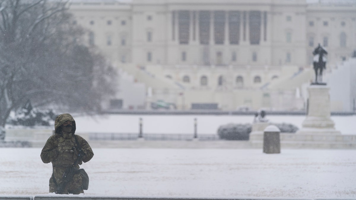 A National Guard soldier stands a post as snow falls in front of the U.S Capitol, Sunday, Jan. 31, 2021, in Washington. (AP Photo/Alex Brandon)