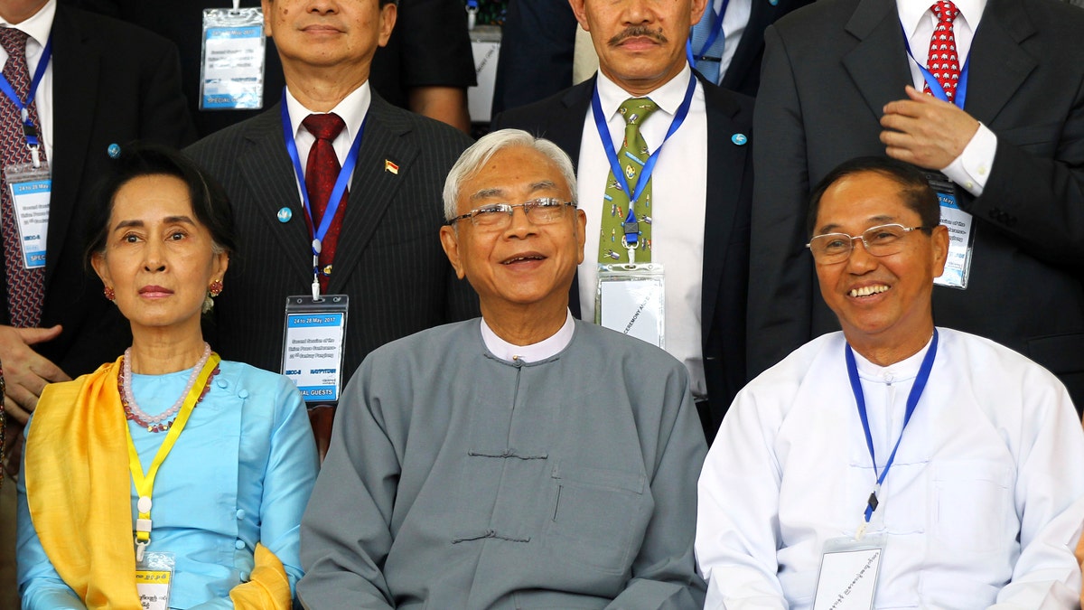 FILE - In this May 24, 2017, file photo, Myanmar's Vice President Myint Swe, right, smiles while sitting with State Counsellor Aung San Suu Kyi, left, and then President Htin Kyaw during a photo session after the second session of the 21st Century Panglong Union Peace Conference at the Myanmar International Convention Center in Naypyitaw, Myanmar. (AP Photo/Aung Shine Oo, File)