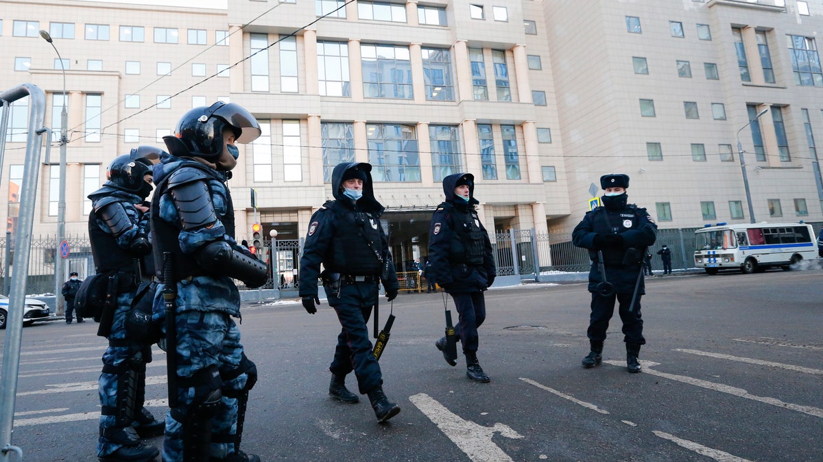 Police block an area around a building where a court will consider a motion from the Russian prison service to convert the suspended sentence of Russian opposition leader Alexei Navalny from the 2014 criminal conviction into a real prison term in Moscow, Russia, Tuesday, Feb. 2, 2021. (AP Photo/Alexander Zemlianichenko)