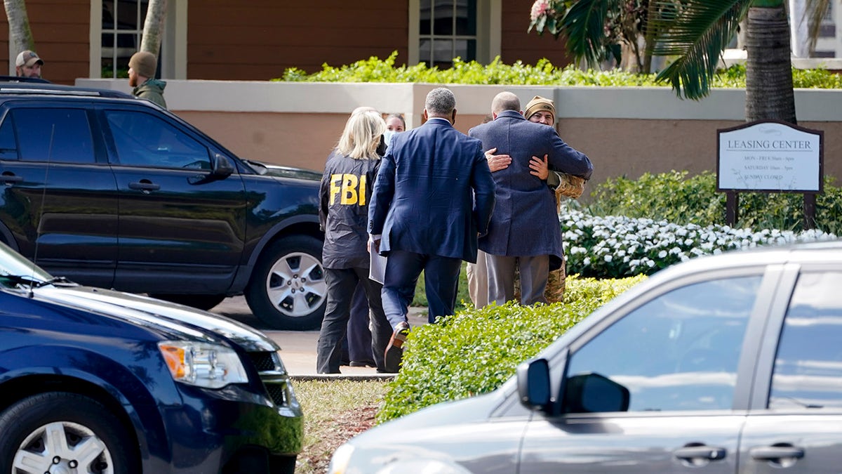Law enforcement officers work where a shooting occurred wounded several FBI personnel while serving an arrest warrant, Tuesday, Feb. 2, 2021, in Sunrise, Fla. Police in South Florida have swarmed a neighborhood following a Tuesday morning shooting involving FBI agents. (AP Photo/Marta Lavandier)